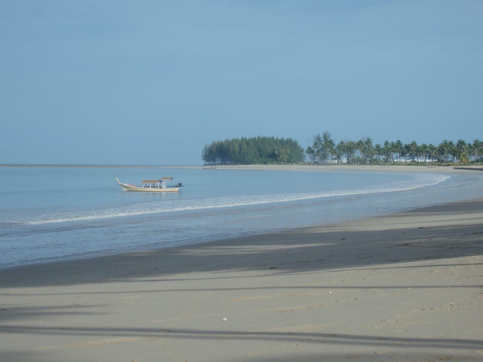 Bang Sak Beach, Bang Muang, with a longtail boat at anchor